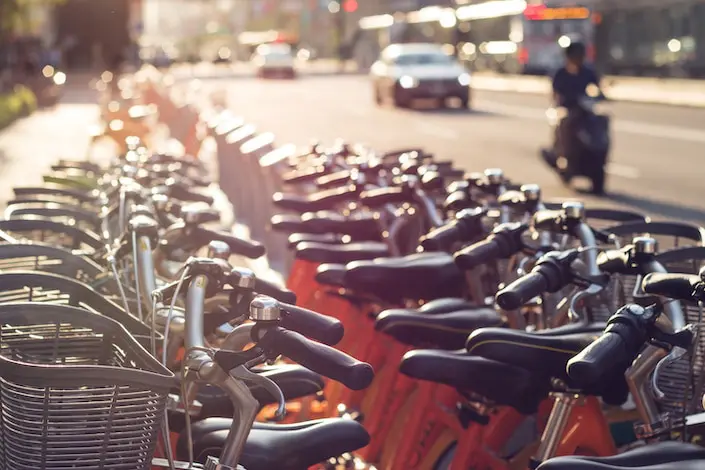 a row of shared bicycles sitting beside a road in China